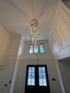 Top-notch Chandelier illuminating a foyer.