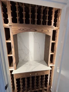 Oak wine rack with a marble countertop in a stylish storage area.